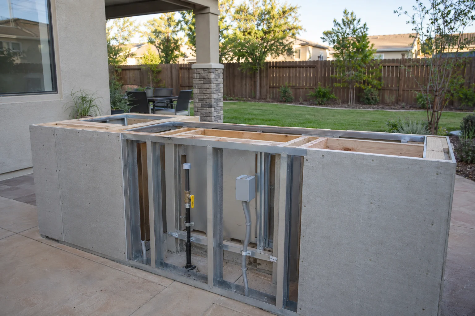 Outdoor kitchen frame with utility lines before finishing