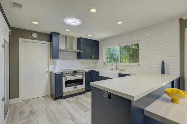 Kitchen with navy cabinets and a white counter