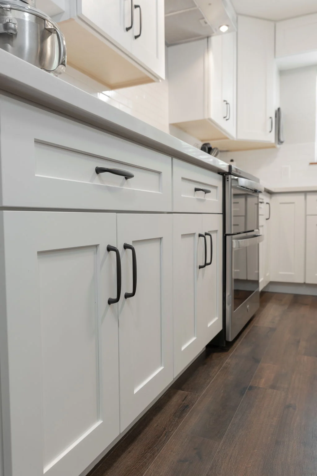 White shaker cabinets beside a range
