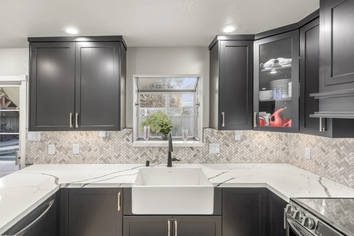 Kitchen with black cabinets and a white farmhouse sink