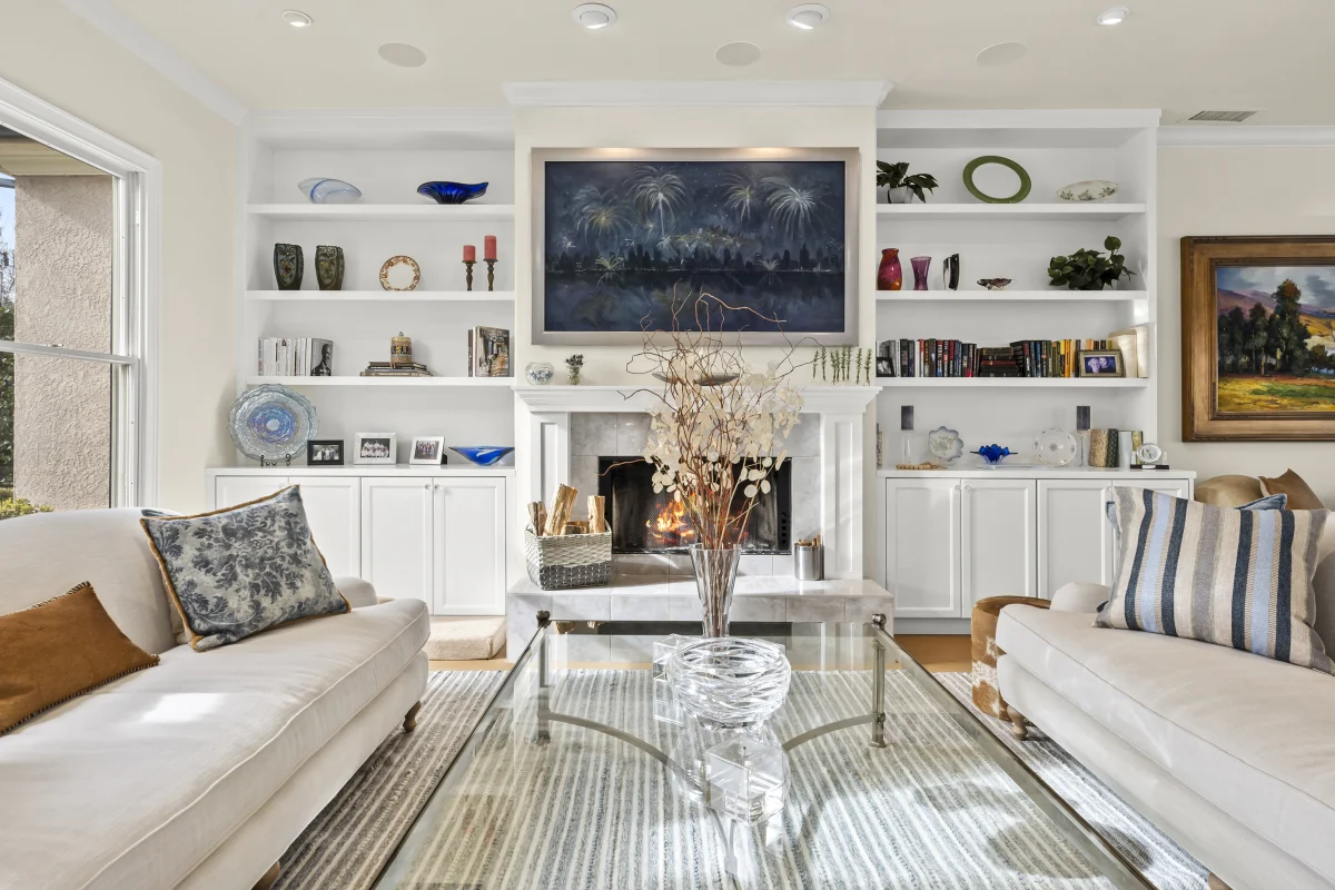 Living room with built-in shelves around a fireplace