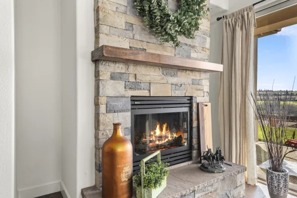Stone fireplace with a wood mantel