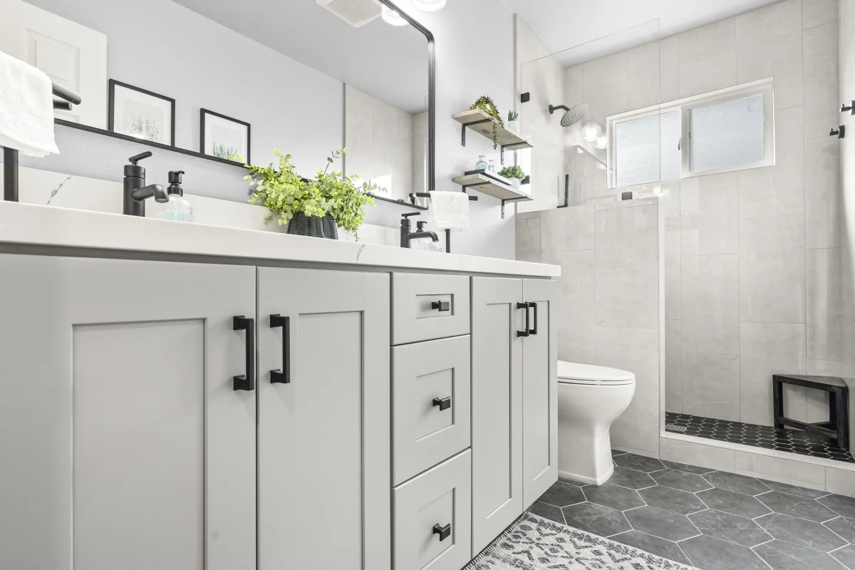Bathroom with a gray vanity, white counter and hexagon floor tile