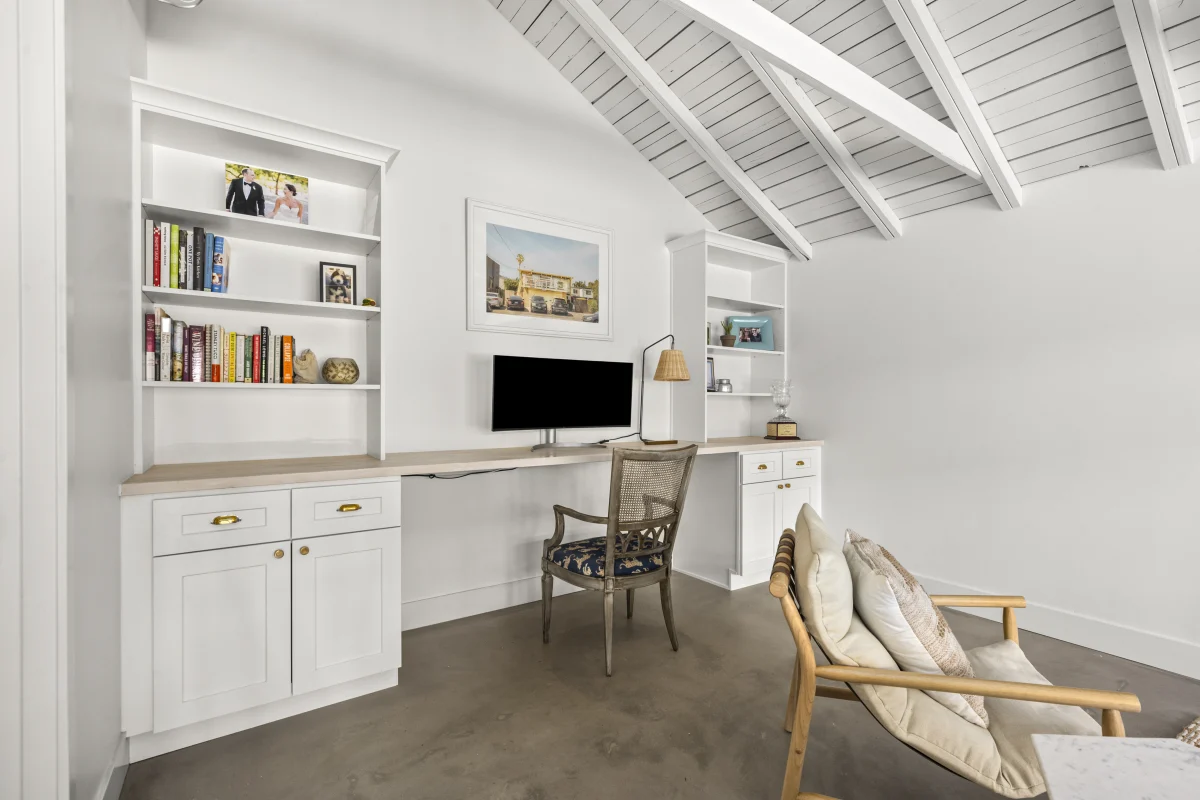 Garage converted to a home office with built-in shelves and a desk