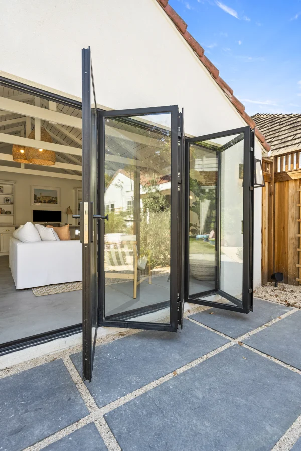 Folding glass doors open from a converted garage