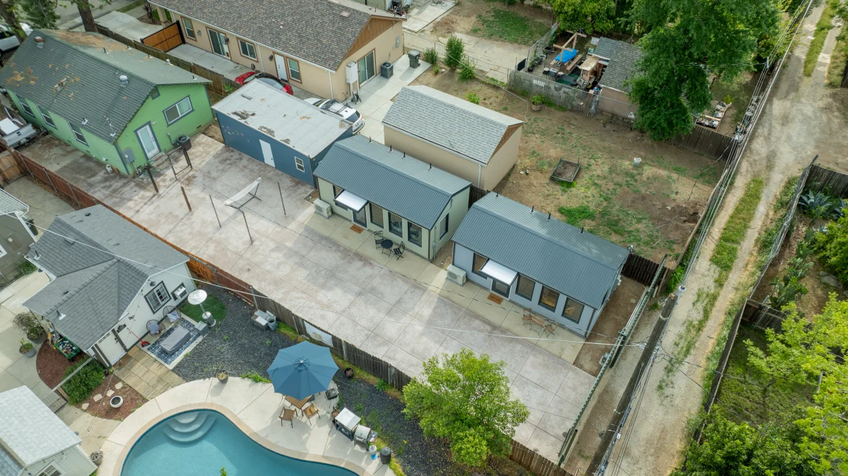 Aerial view of two backyard units and a pool