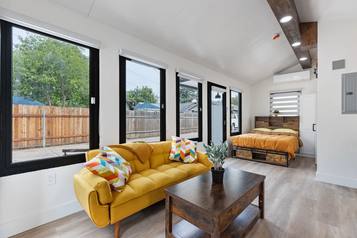 Backyard unit living room with black-framed windows
