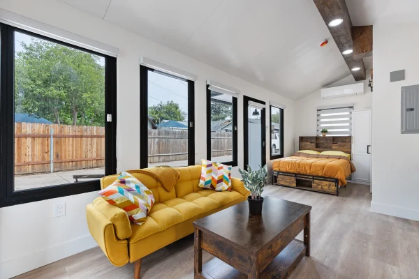 Backyard unit living room with black-framed windows
