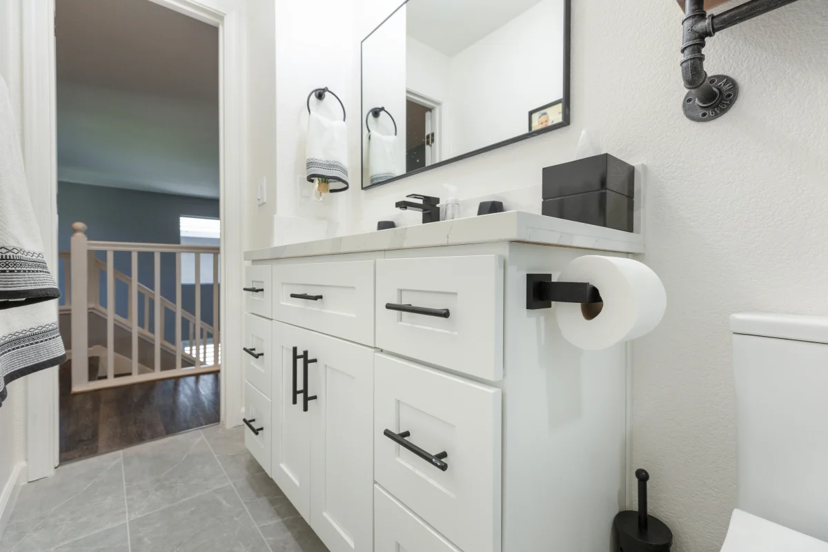 Bathroom with a white vanity and black fixtures