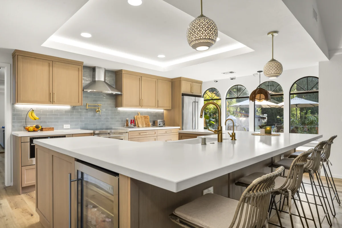 Kitchen with a white island and pendant lights