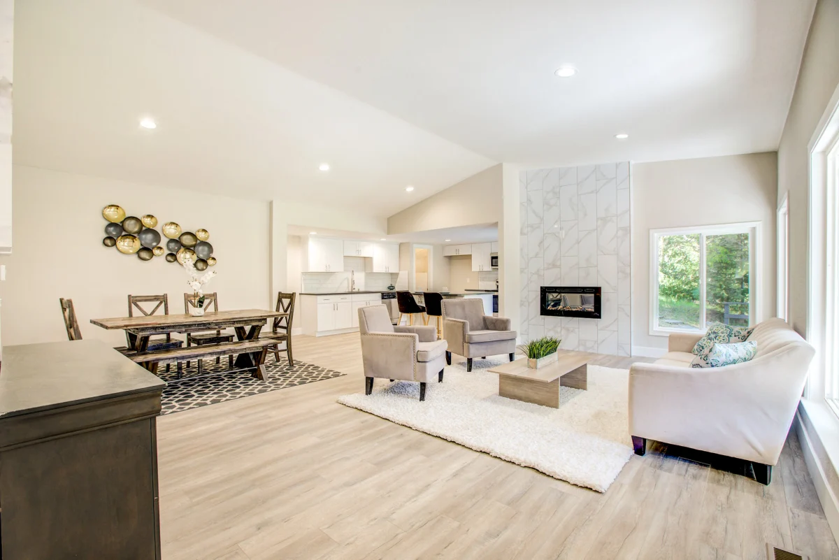 Open living and dining room with a tiled fireplace wall