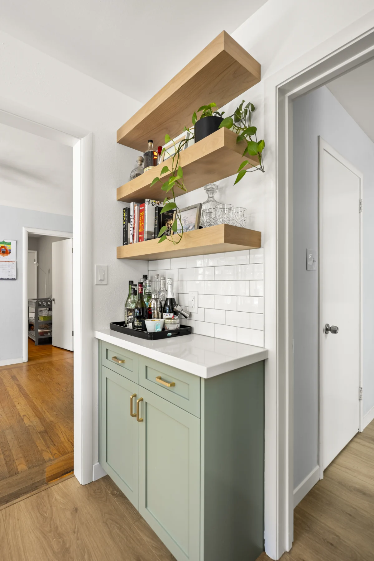 Coffee station with sage cabinets and open shelves
