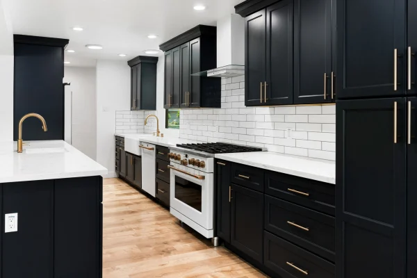Kitchen with black cabinets and white subway tile