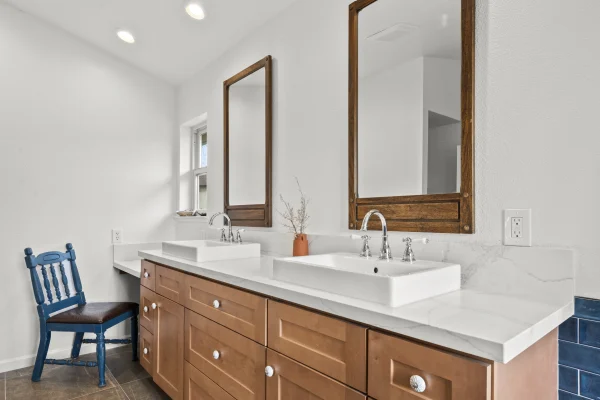 Bathroom with a wood vanity and two mirrors