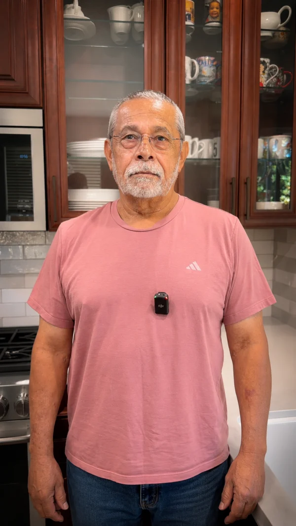 Homeowner standing in a kitchen with cherry wood cabinets