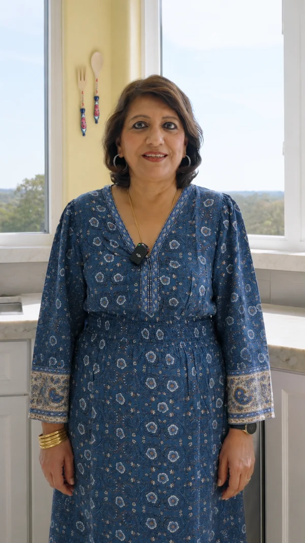 Homeowner standing in a bright room by a window