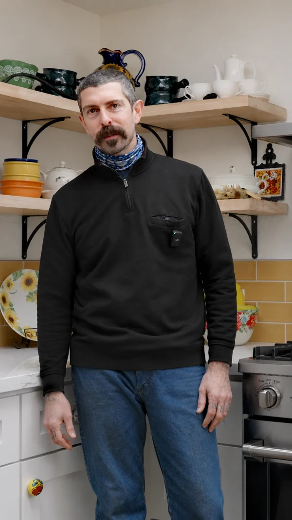 Homeowner standing in a kitchen with open shelves