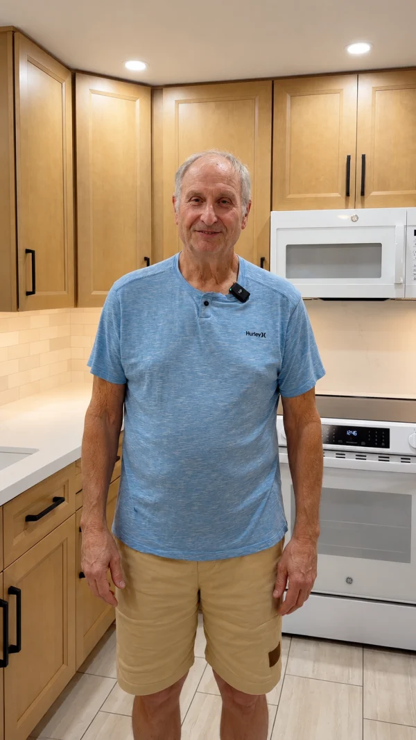 Homeowner standing in a kitchen with light wood cabinets