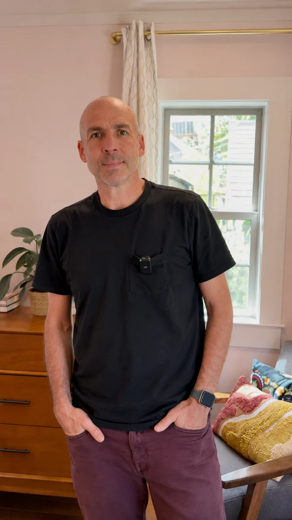 Homeowner standing in a room beside a window