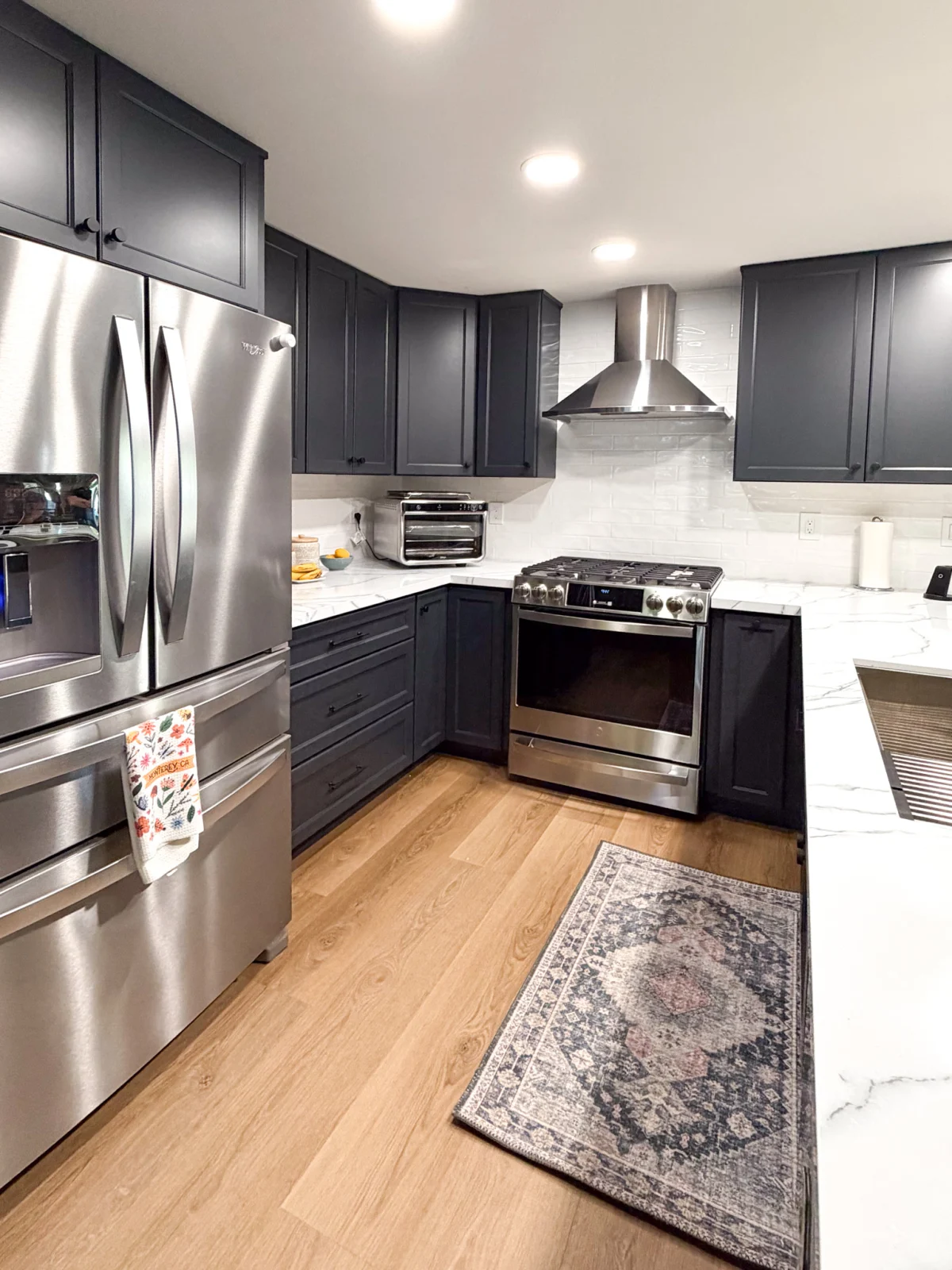 Kitchen with dark gray cabinets and stainless appliances