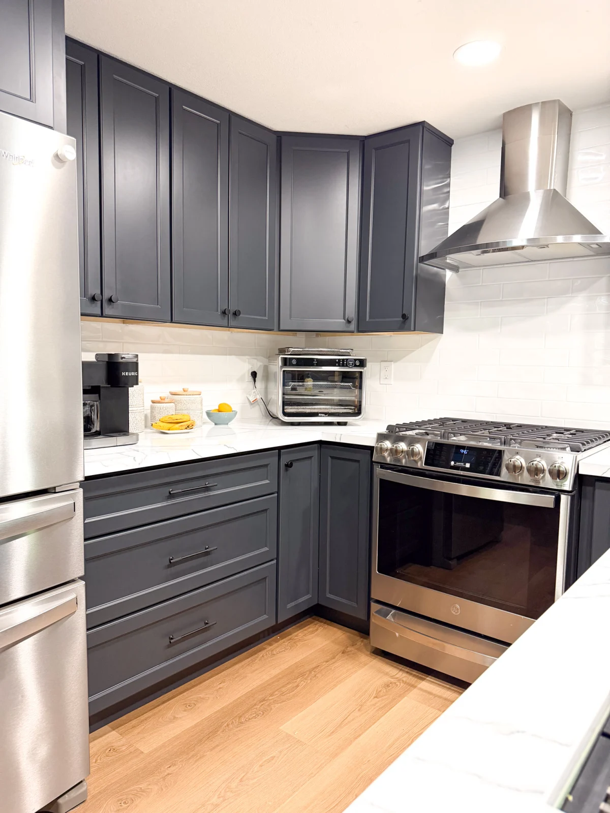 Kitchen with dark gray cabinets and stainless appliances