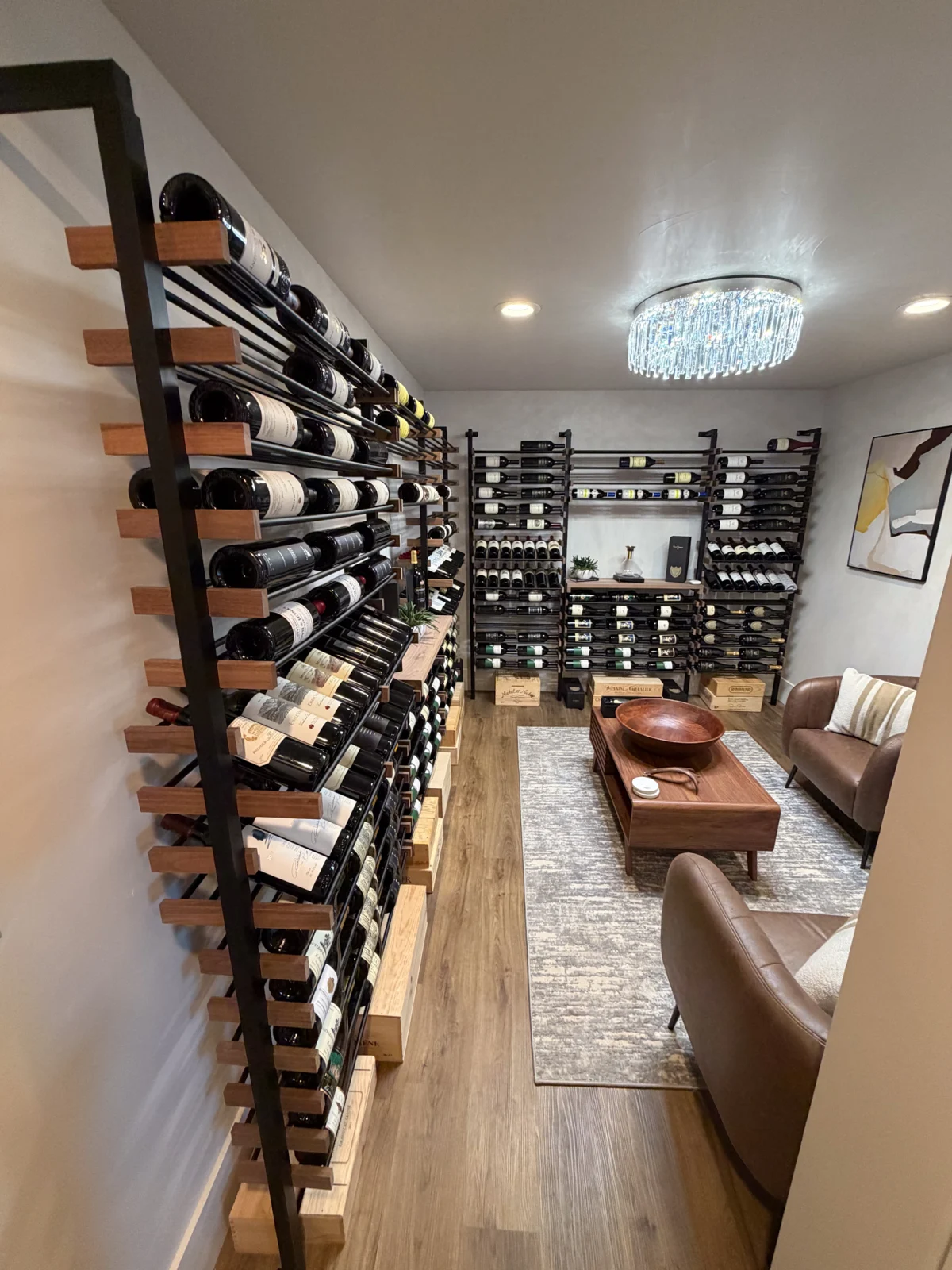 Basement wine room with wall-mounted racks and a leather sofa