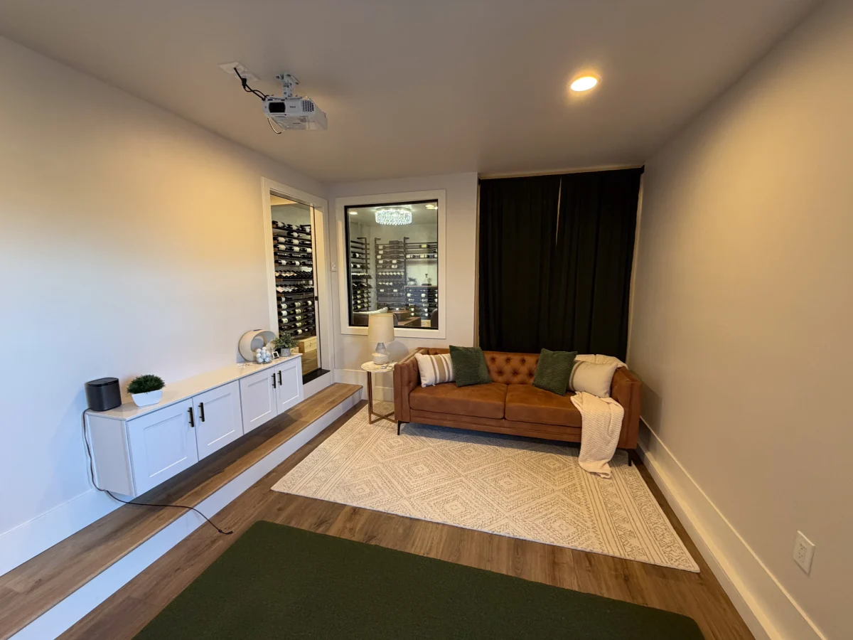 Basement lounge with a leather sofa and wine storage