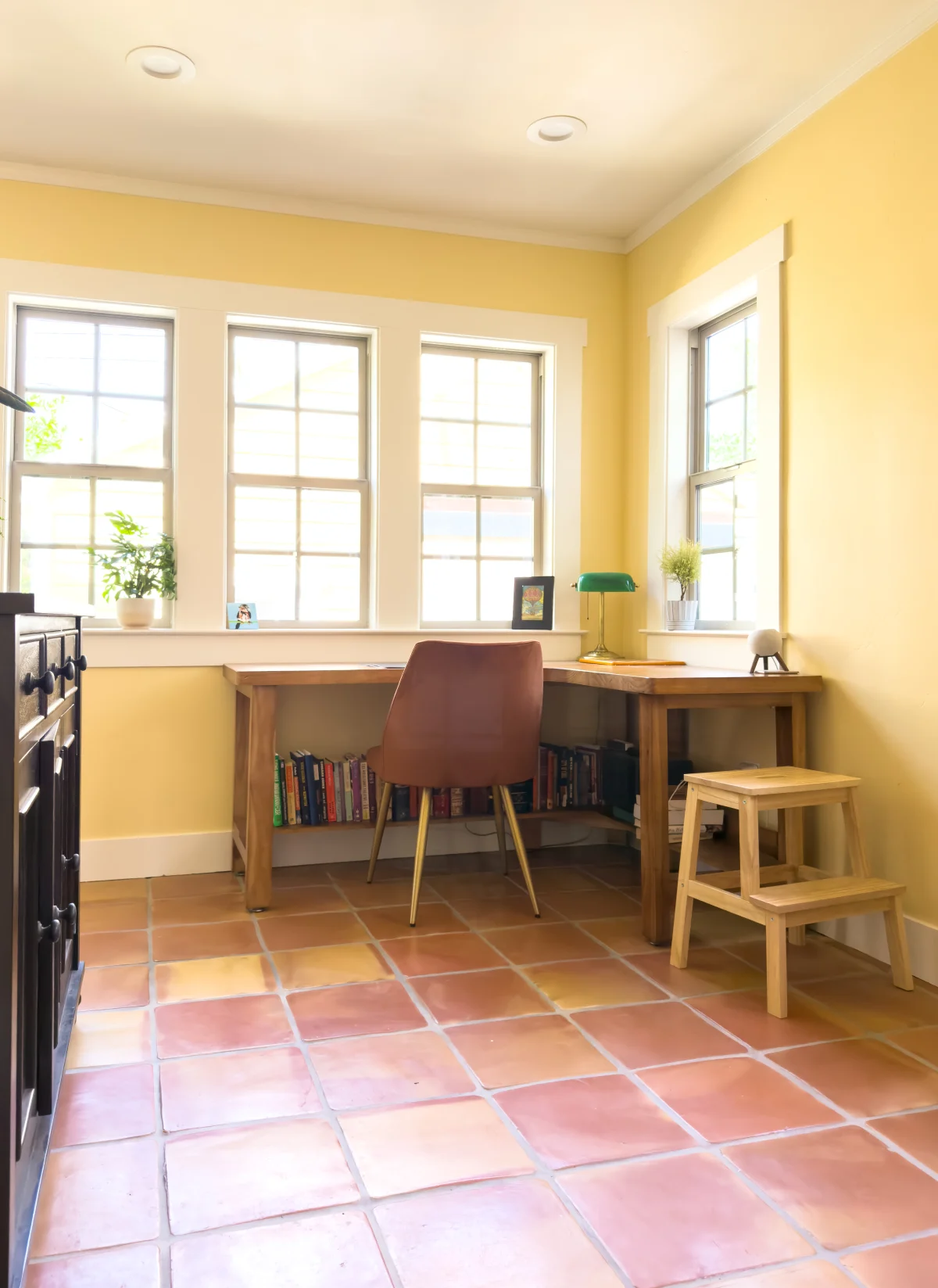 Bright room with a desk and terracotta tile floor