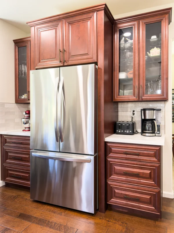 Kitchen with cherry cabinets and a stainless fridge