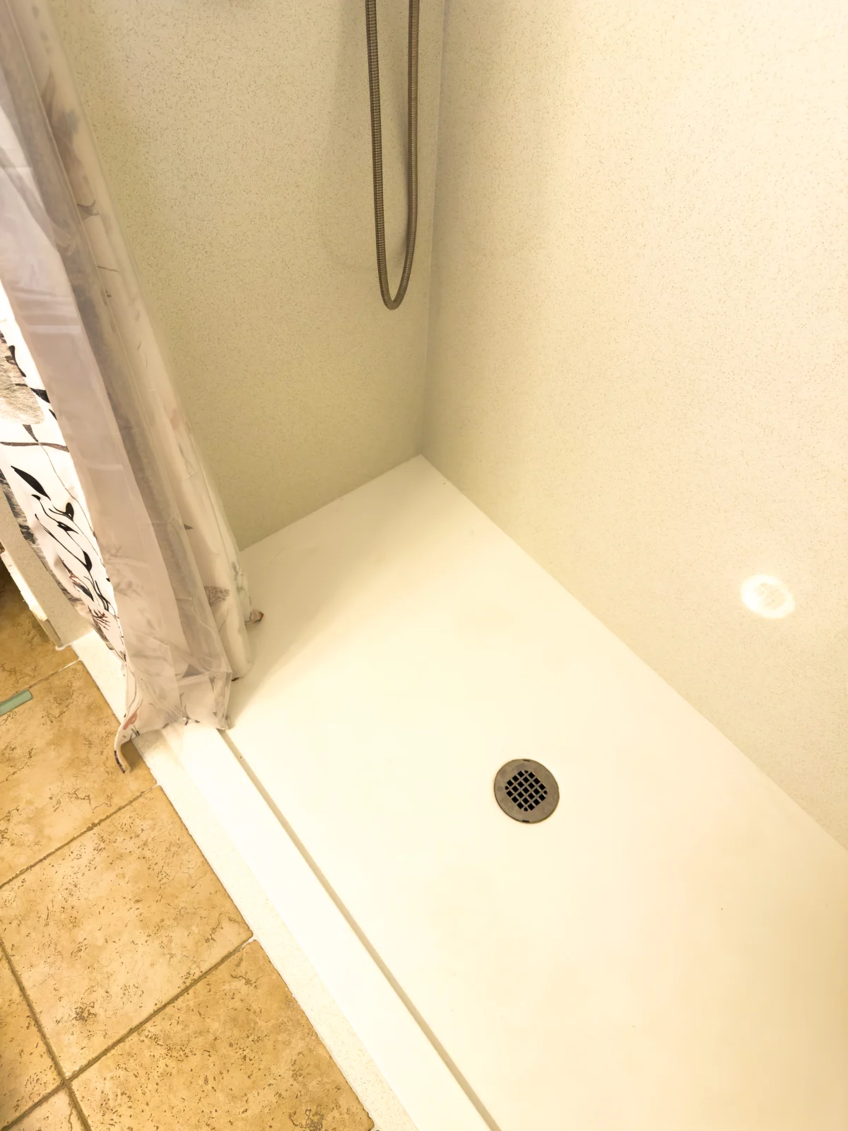 White shower base in a tub-to-shower conversion