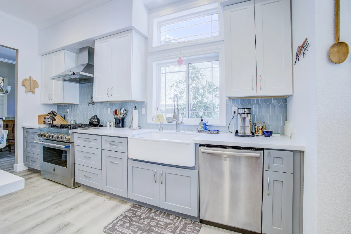 Kitchen with gray lower cabinets and a farmhouse sink