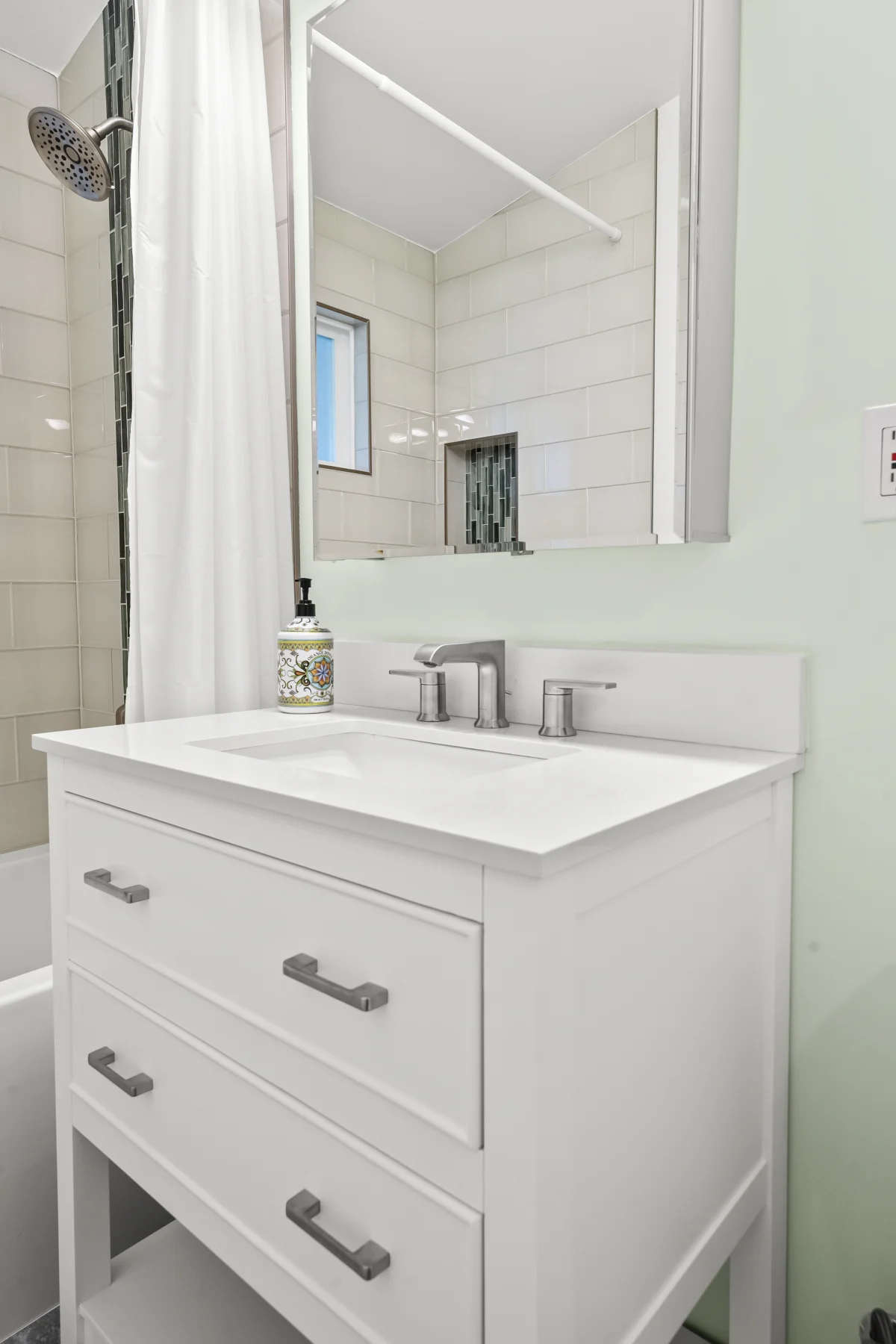 Small bathroom with a white vanity and shower curtain