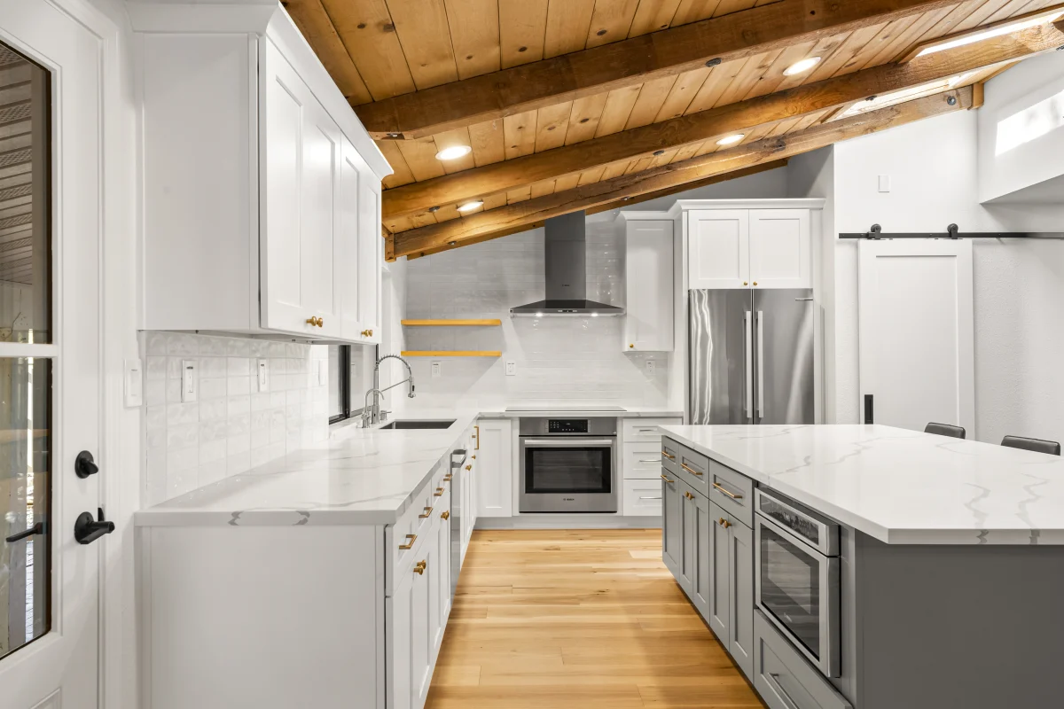 Kitchen with a wood plank ceiling and gray island