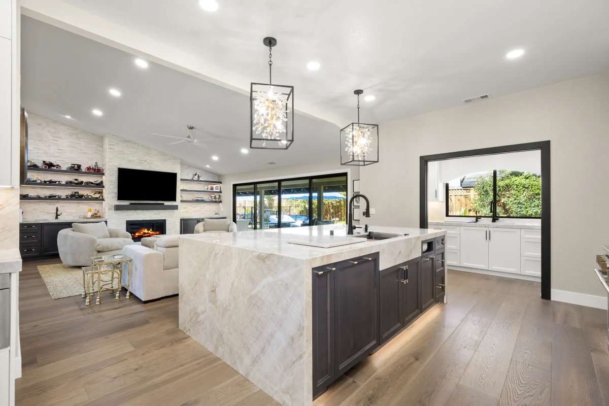 Kitchen with a marble island open to a living room