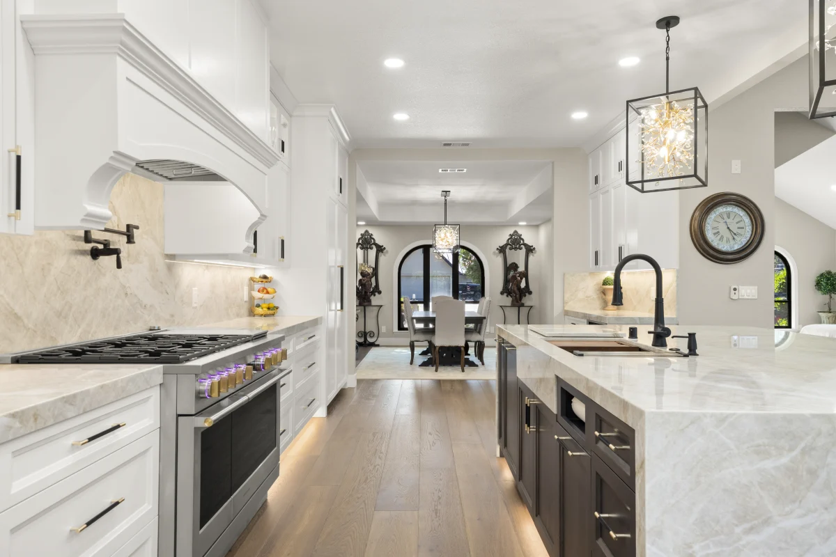 Kitchen with a marble island and dark base cabinets