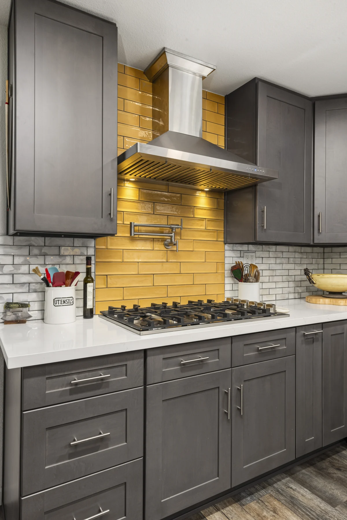 Kitchen with gray cabinets and a mustard tile backsplash