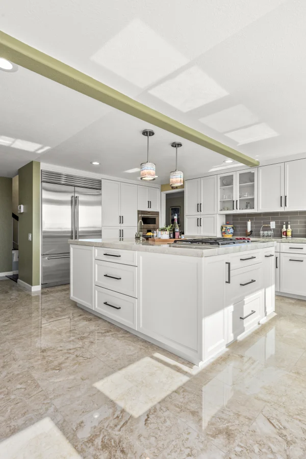 White kitchen with an island and skylights