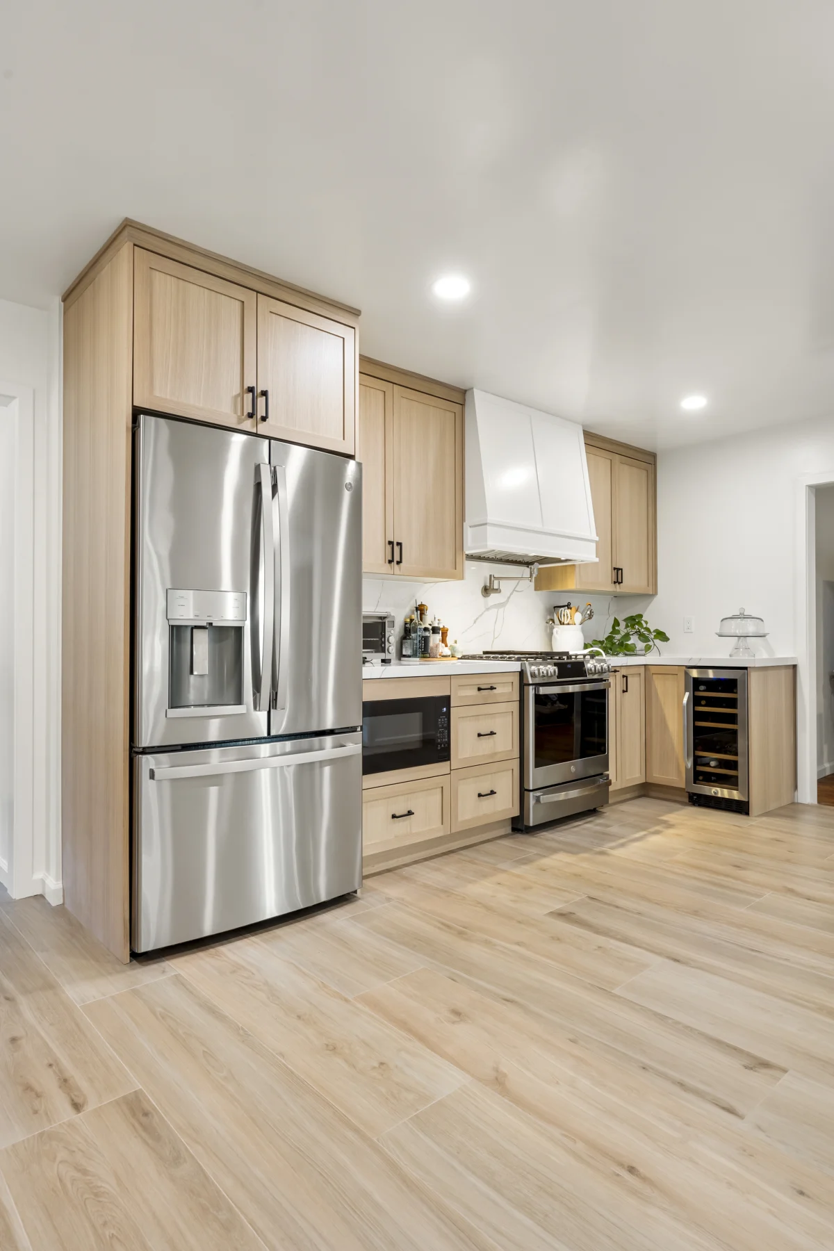 Kitchen with light wood cabinets and stainless appliances