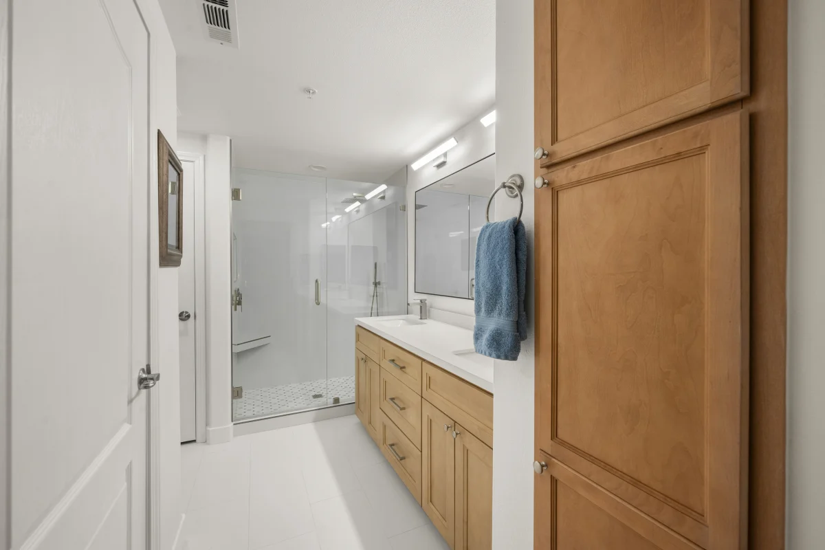 Bathroom with a wood vanity and a glass-enclosed shower