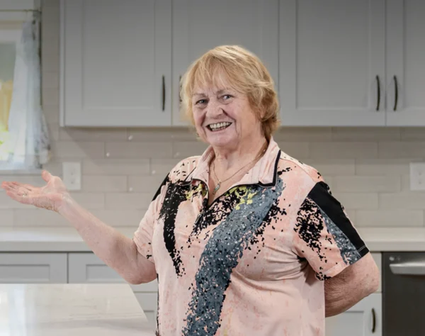 Homeowner standing in her kitchen
