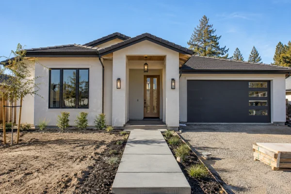 New stucco house with a fresh concrete front walkway