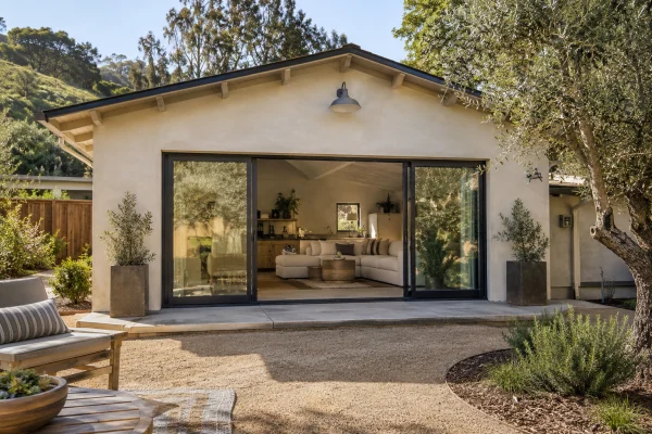 Former garage opening fitted with a wide sliding glass door