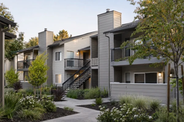 Three-story apartment buildings with balconies and exterior stairs