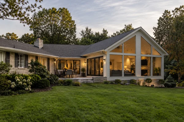 Single-story house with a glass-gabled great room facing the lawn