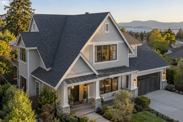 Two-story house with a steep charcoal shingle roof