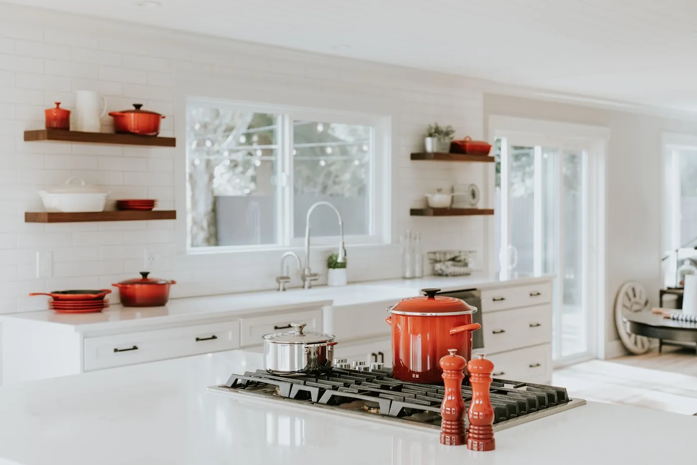 Bright kitchen with painted cabinetry and stone counters
