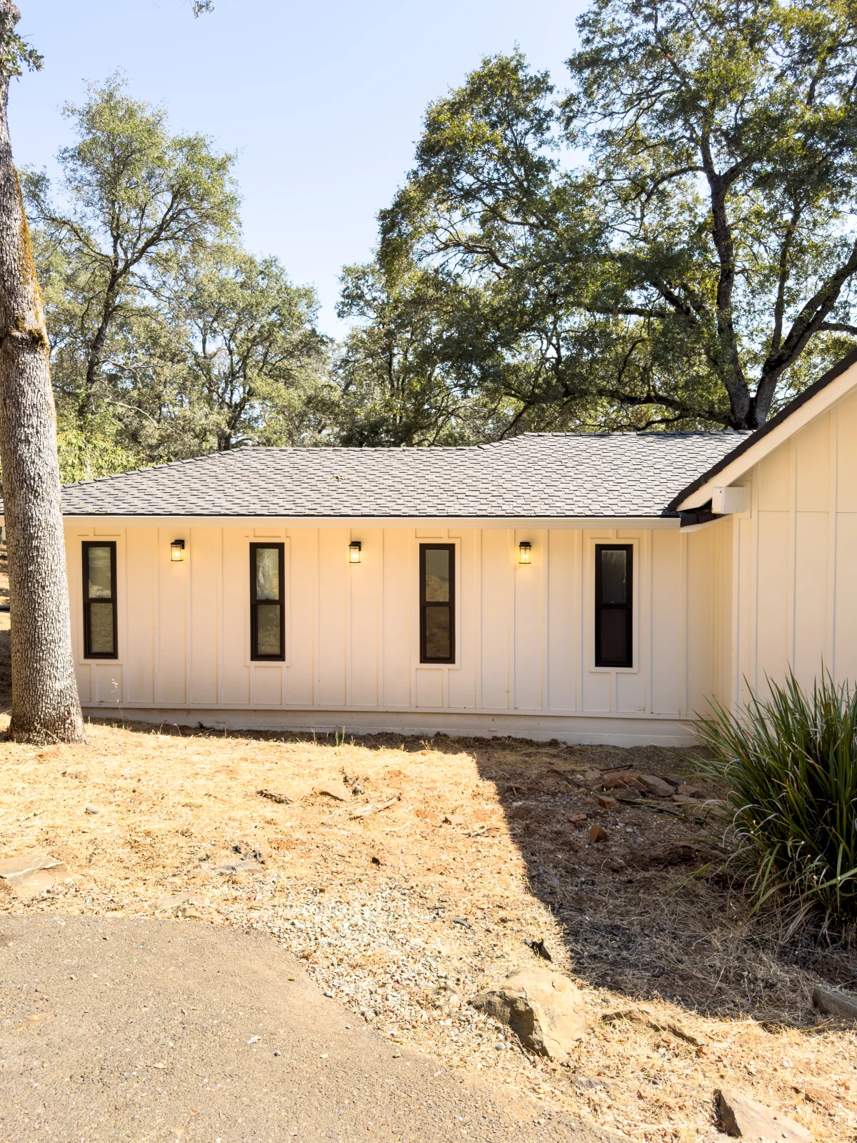 Single-story addition with board-and-batten siding and wall lights