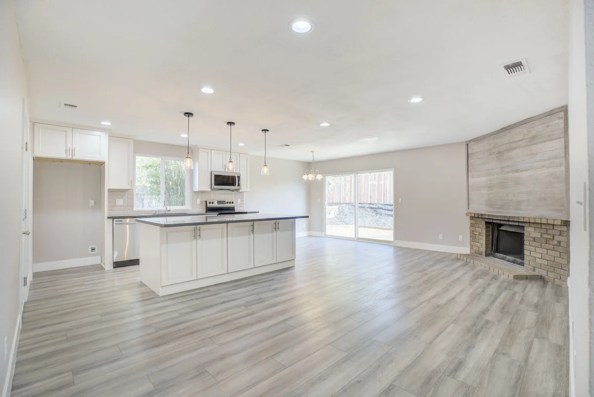 Open kitchen and living room with a tile fireplace