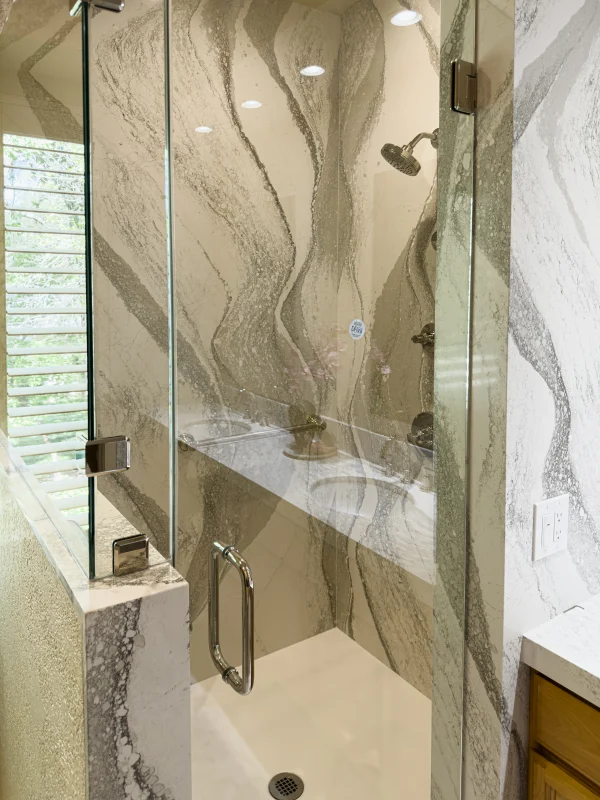 Glass shower with marble-look tile
