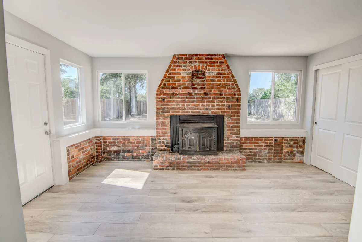 Room with a brick fireplace and new floors